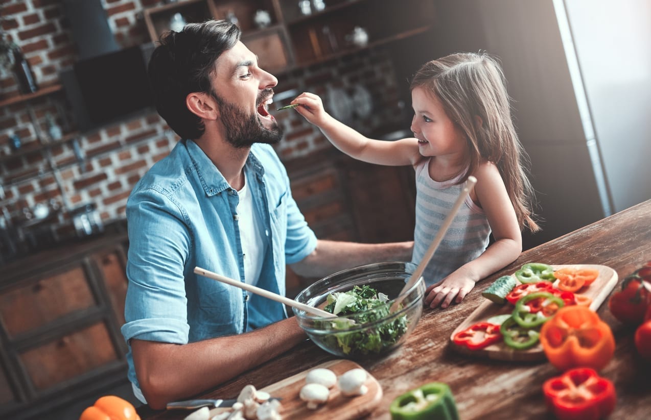 Dad and daughter cooking together