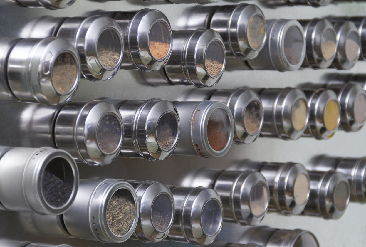 metallic magnetic spice cans at a reflective wall