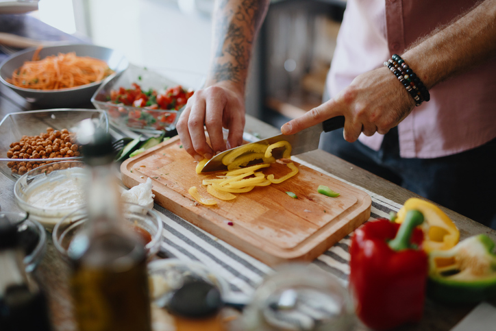 chef cutting peppers